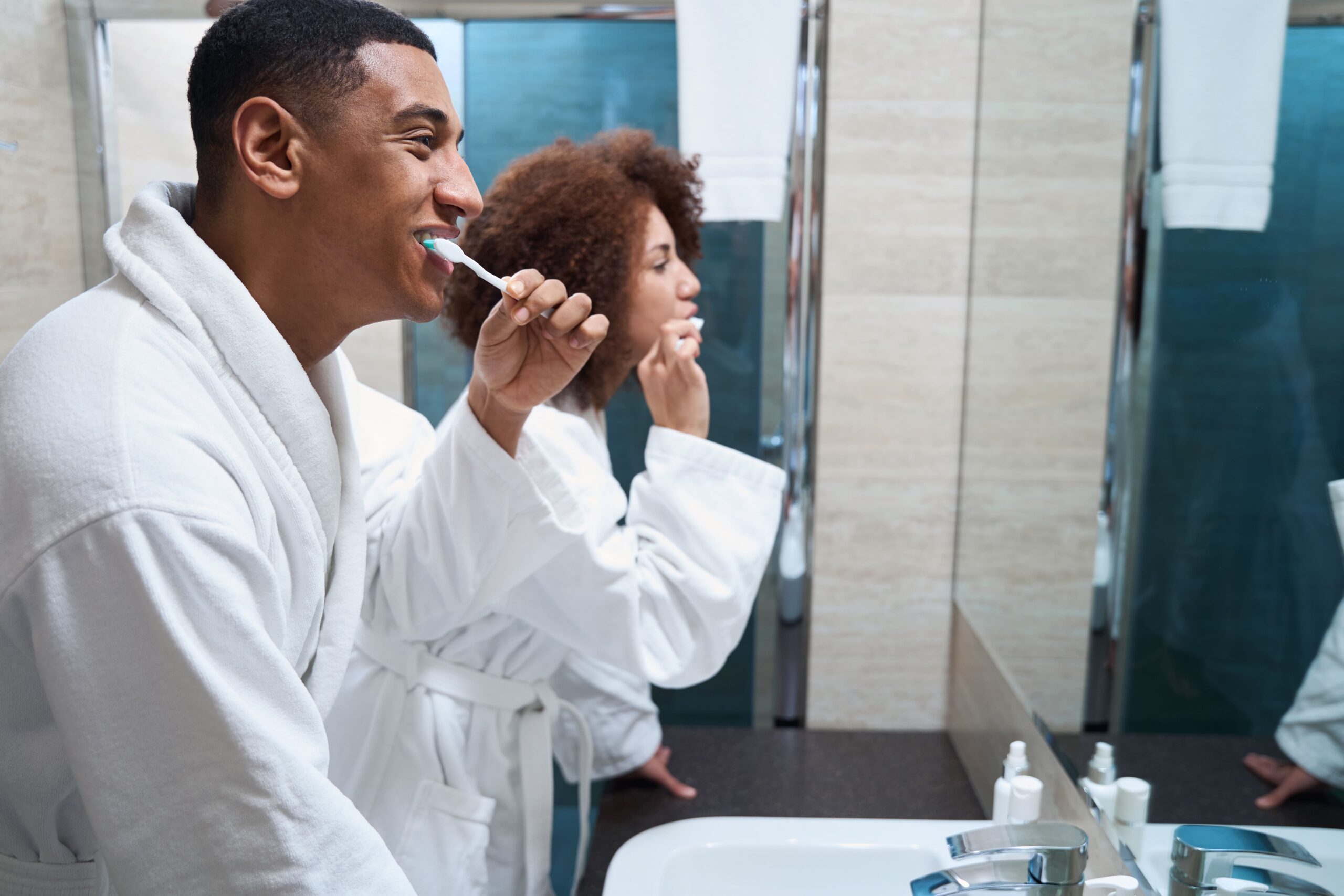 Couple in bathroom brushing teeth