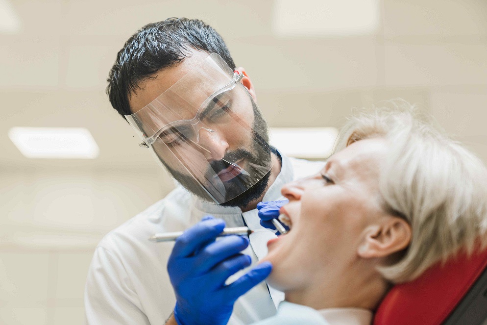 Doctor performing an oral cancer check